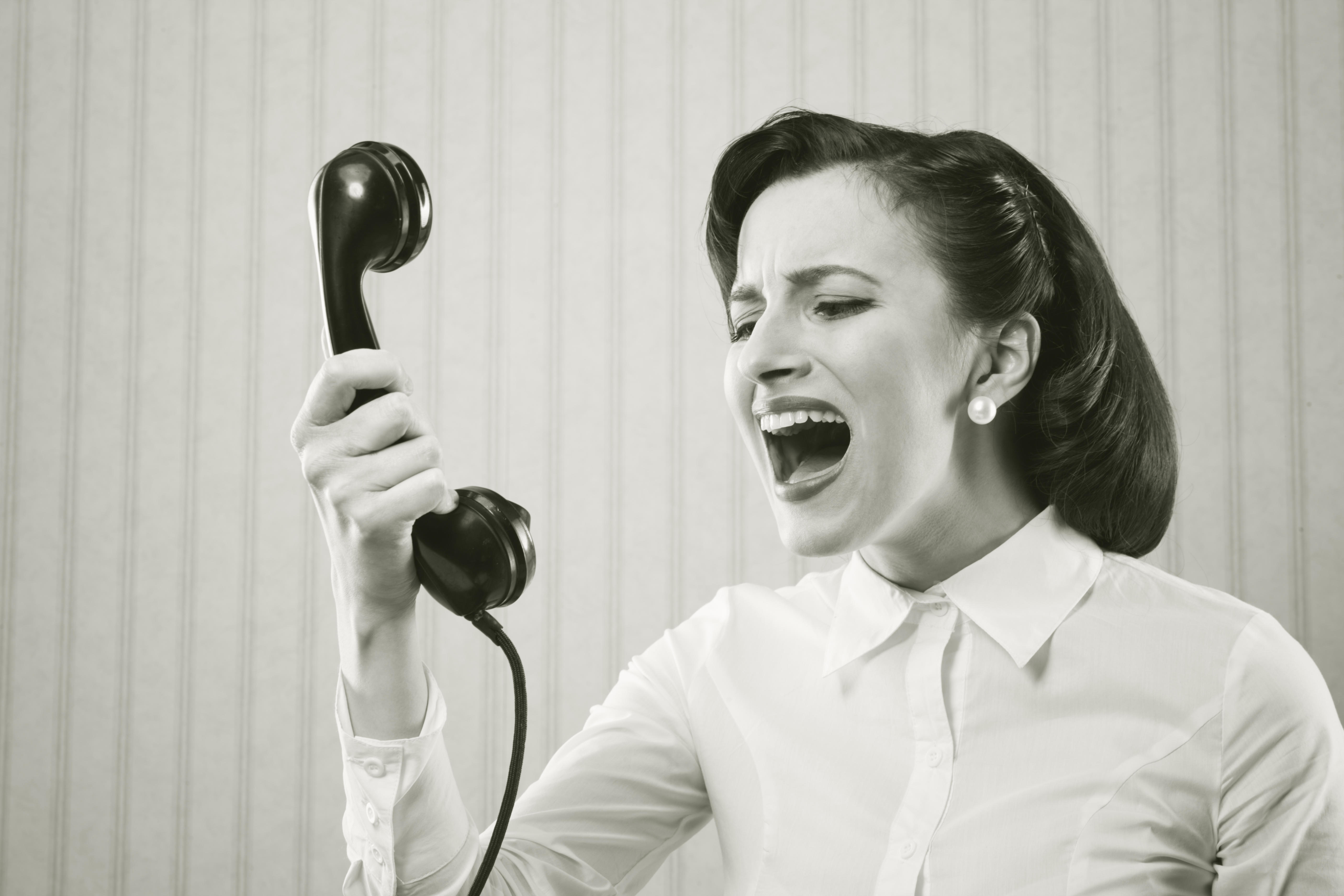 Young Woman shouting into telephone